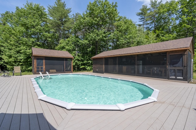 16 Keystone Spring Rd, Poland, ME 04274 - outdoor pool featuring a sunroom, a wooden deck, and view of wooded area