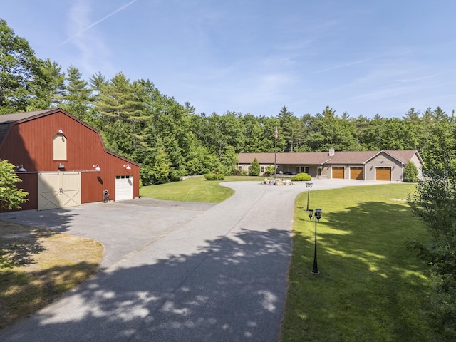 16 Keystone Spring Rd, Poland, ME 04274 - view of front of property with a barn, a gambrel roof, a front yard, asphalt driveway, and an outbuilding