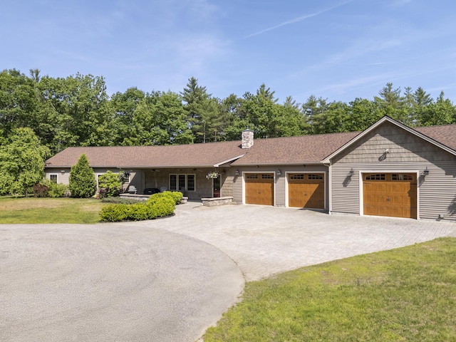 16 Keystone Spring Rd, Poland, ME 04274 - single story home with a garage, decorative driveway, a front lawn, a chimney, and a shingled roof