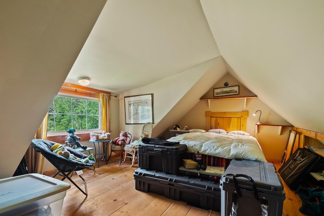 574 Mingo Loop Rd, Rangeley, ME 04970 - bedroom with vaulted ceiling and hardwood / wood-style floors
