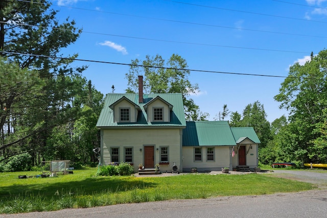 574 Mingo Loop Rd, Rangeley, ME 04970 - view of front of property with a metal roof, entry steps, a chimney, and a front lawn