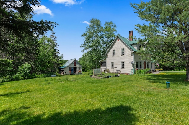 574 Mingo Loop Rd, Rangeley, ME 04970 - view of side of home with a chimney and a yard