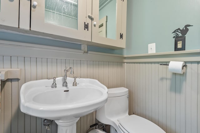574 Mingo Loop Rd, Rangeley, ME 04970 - bathroom with toilet and wainscoting