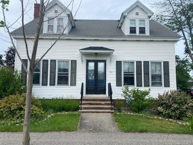 86 Summer St, Saco, ME 04072 - view of front of property featuring french doors, a chimney, and roof with shingles