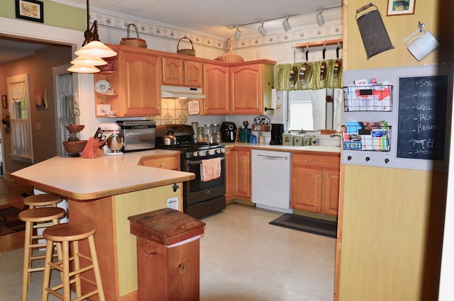 86 Summer St, Saco, ME 04072 - kitchen with dishwasher, under cabinet range hood, gas stove, a peninsula, and a breakfast bar