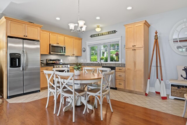 71 Village Way Unit 506, Edgecomb, ME 04556 - kitchen with appliances with stainless steel finishes, light brown cabinets, a chandelier, light tile patterned floors, and recessed lighting