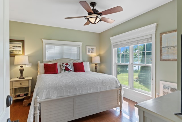 71 Village Way Unit 506, Edgecomb, ME 04556 - bedroom with multiple windows, wood finished floors, and a ceiling fan