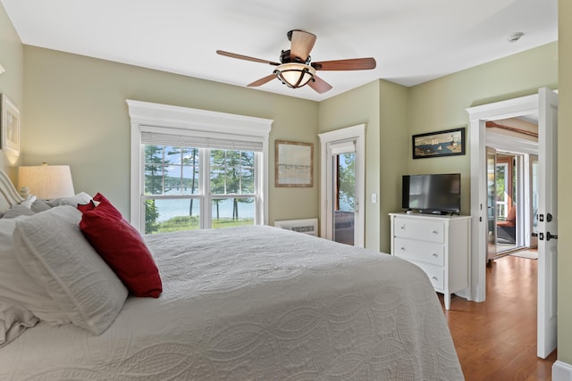 71 Village Way Unit 506, Edgecomb, ME 04556 - bedroom with access to exterior, wood finished floors, and ceiling fan
