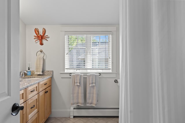 71 Village Way Unit 506, Edgecomb, ME 04556 - bathroom with a baseboard heating unit, vanity, and tile patterned floors