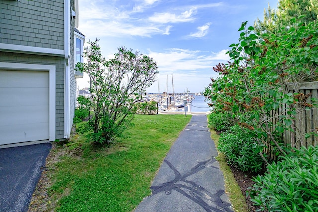 148 Breakwater Dr Unit 17, South Portland, ME 04106 - view of grassy yard with a water view and a garage
