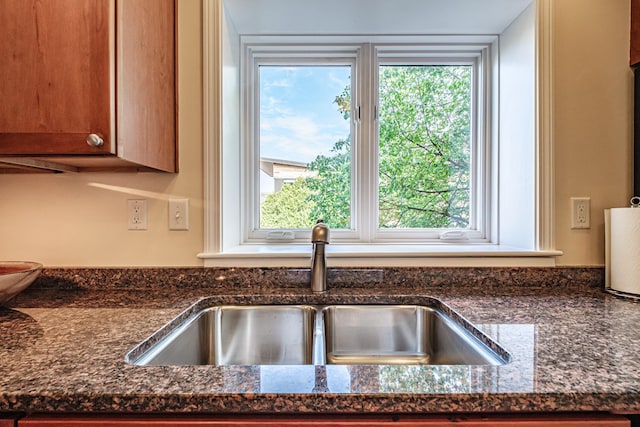 148 Breakwater Dr Unit 17, South Portland, ME 04106 - kitchen with brown cabinets and dark stone countertops