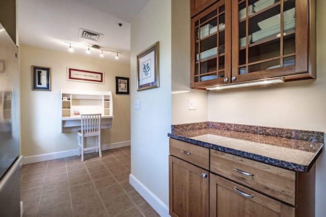 148 Breakwater Dr Unit 17, South Portland, ME 04106 - kitchen featuring glass insert cabinets, freestanding refrigerator, and dark tile patterned flooring