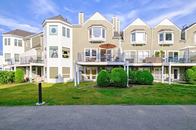 148 Breakwater Dr Unit 17, South Portland, ME 04106 - back of house with a chimney and a yard