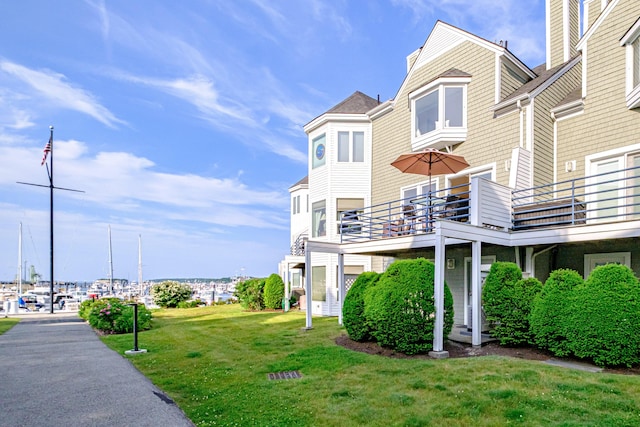 148 Breakwater Dr Unit 17, South Portland, ME 04106 - view of property exterior featuring a balcony and a lawn