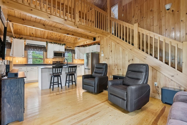 8 Log Cabin Ln Unit 9, Shapleigh, ME 04076 - living area featuring wood walls, light wood-style floors, and a wood ceiling with exposed beams