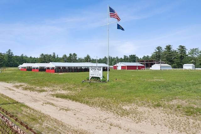 8 Log Cabin Ln Unit 9, Shapleigh, ME 04076 - exterior space featuring an outbuilding, view of wooded area, and a front yard