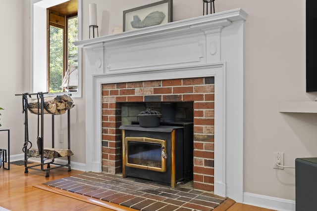 15 Harvey Brook Dr, Freeport, ME 04032 - detailed view of wood finished floors, a wood stove, and a fireplace