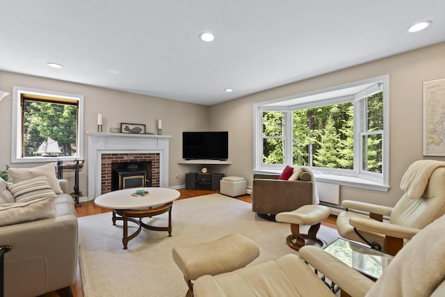 15 Harvey Brook Dr, Freeport, ME 04032 - living area with healthy amount of natural light, wood finished floors, recessed lighting, a fireplace, and baseboard heating