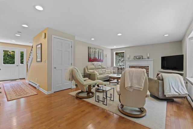 15 Harvey Brook Dr, Freeport, ME 04032 - living area featuring a baseboard radiator, light wood-type flooring, recessed lighting, and a fireplace
