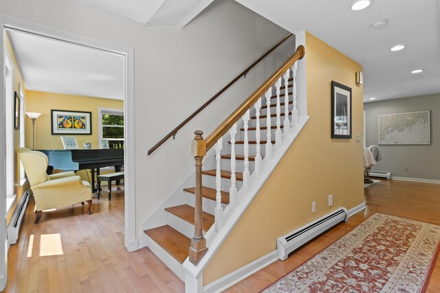 15 Harvey Brook Dr, Freeport, ME 04032 - stairs featuring a baseboard heating unit, a baseboard radiator, wood finished floors, and recessed lighting
