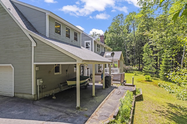 15 Harvey Brook Dr, Freeport, ME 04032 - back of property featuring a yard, roof with shingles, and driveway