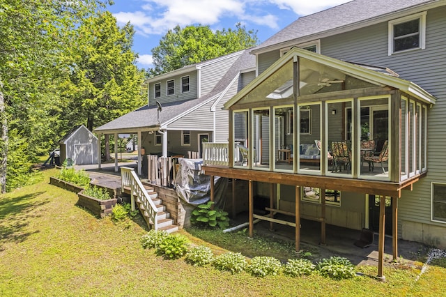 15 Harvey Brook Dr, Freeport, ME 04032 - back of property featuring a sunroom, a shed, roof with shingles, a wooden deck, and a yard