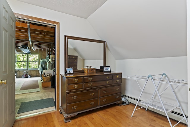 15 Harvey Brook Dr, Freeport, ME 04032 - bedroom with a baseboard radiator, light wood finished floors, vaulted ceiling, and a closet