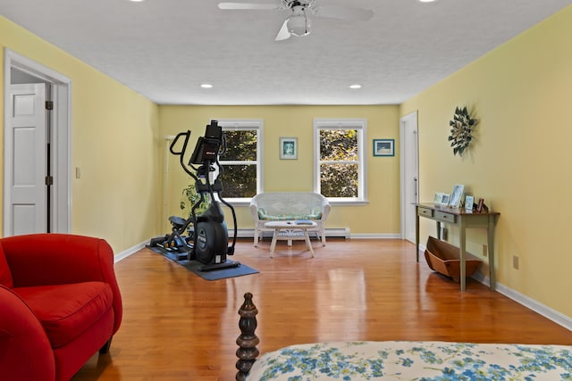 15 Harvey Brook Dr, Freeport, ME 04032 - workout area featuring wood finished floors, a baseboard radiator, a ceiling fan, and recessed lighting