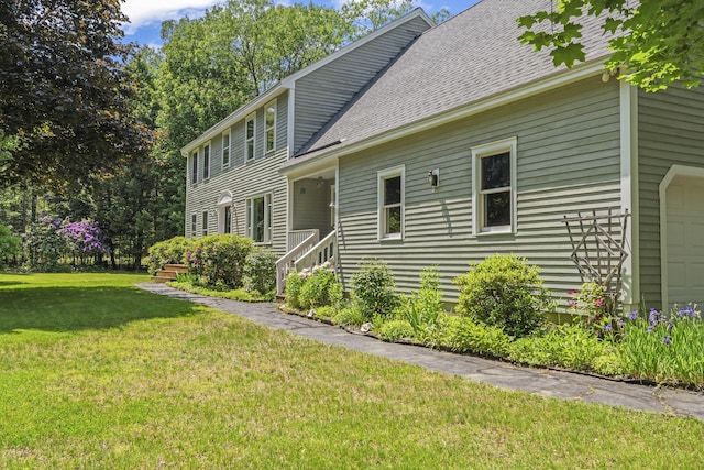 15 Harvey Brook Dr, Freeport, ME 04032 - view of side of property featuring a lawn, roof with shingles, and a garage
