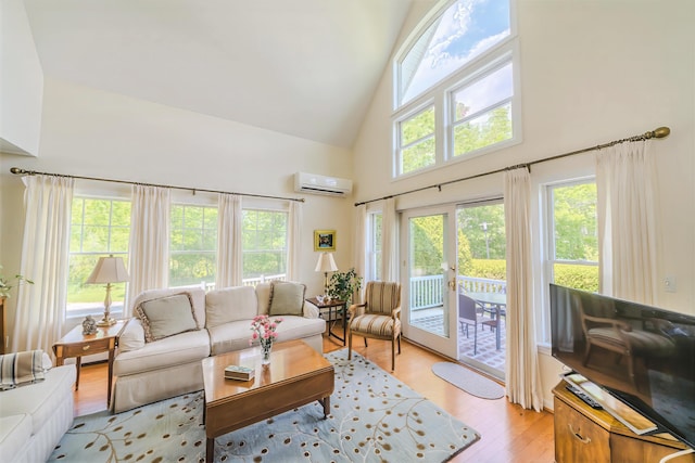 97 Dockside Ln Unit 8, Belfast, ME 04915 - living room with high vaulted ceiling, an AC wall unit, and light wood-type flooring