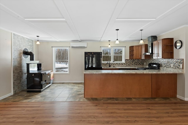 431 Bardon Hill Rd, Etna, ME 04434 - kitchen featuring open shelves, black appliances, an AC wall unit, a wood stove, and a peninsula