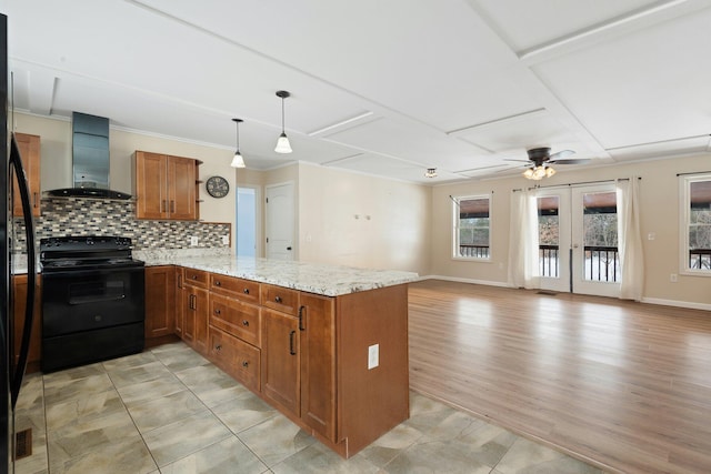 431 Bardon Hill Rd, Etna, ME 04434 - kitchen with wall chimney range hood, electric range, a peninsula, brown cabinets, and ceiling fan