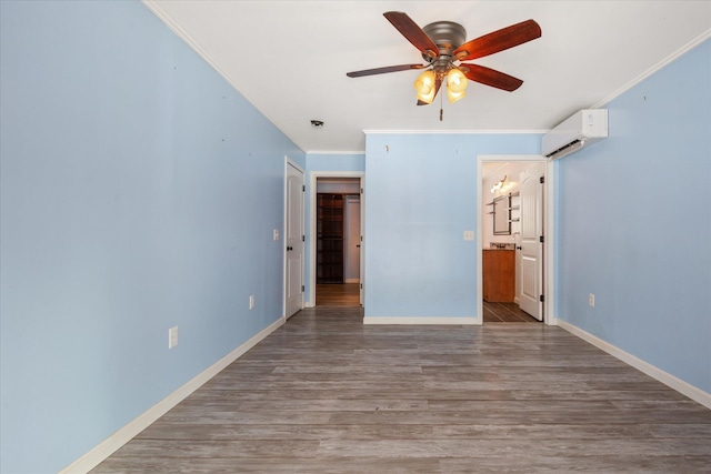 431 Bardon Hill Rd, Etna, ME 04434 - unfurnished bedroom with a wall unit AC, ensuite bathroom, wood finished floors, crown molding, and a ceiling fan