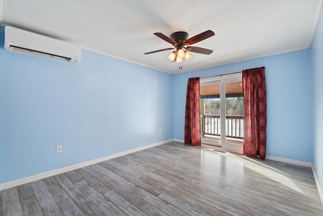 431 Bardon Hill Rd, Etna, ME 04434 - empty room with a wall unit AC, ceiling fan, wood finished floors, and crown molding