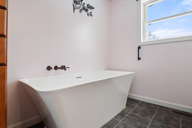 431 Bardon Hill Rd, Etna, ME 04434 - bathroom featuring a freestanding tub and tile patterned flooring