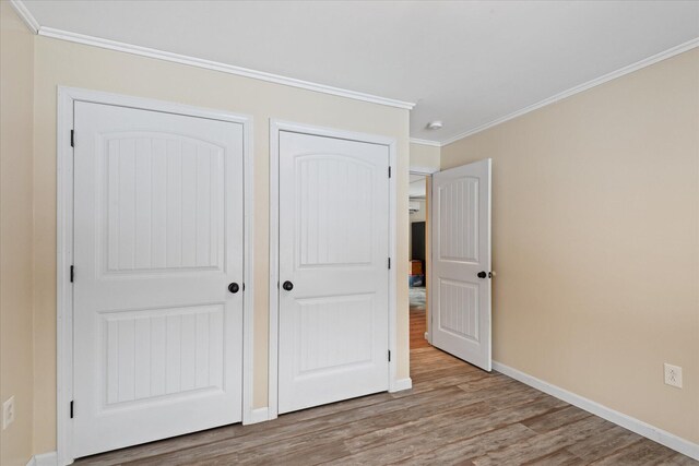 431 Bardon Hill Rd, Etna, ME 04434 - unfurnished bedroom with wood finished floors, ornamental molding, and a closet