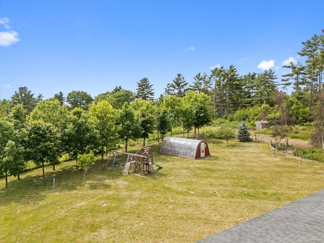 431 Bardon Hill Rd, Etna, ME 04434 - view of green lawn with an outdoor structure, a greenhouse, and view of scattered trees