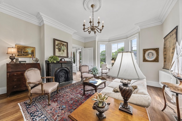 58 Church St, Belfast, ME 04915 - living area featuring a chandelier, crown molding, wood finished floors, and a fireplace with flush hearth