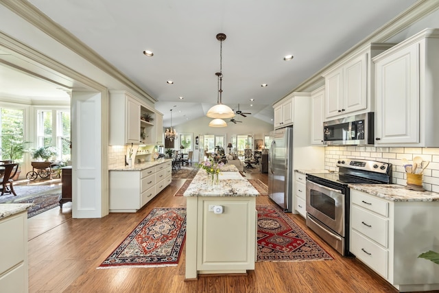 58 Church St, Belfast, ME 04915 - kitchen with appliances with stainless steel finishes, healthy amount of natural light, a center island, wood finished floors, and lofted ceiling