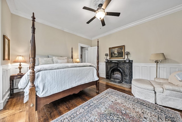 58 Church St, Belfast, ME 04915 - bedroom featuring crown molding, hardwood / wood-style floors, a wainscoted wall, ceiling fan, and a fireplace