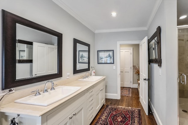 58 Church St, Belfast, ME 04915 - bathroom featuring double vanity, a stall shower, wood finished floors, and ornamental molding