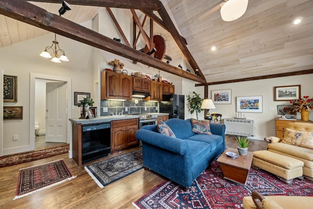 58 Church St, Belfast, ME 04915 - living room featuring a wooden ceiling with exposed beams, wood finished floors, radiator heating unit, a chandelier, and high vaulted ceiling