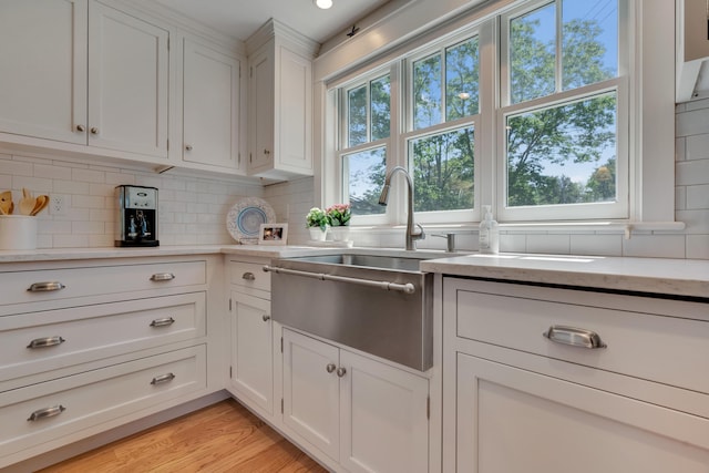 13 Norwood Ln, Kennebunkport, ME 04046 - kitchen featuring tasteful backsplash and white cabinets