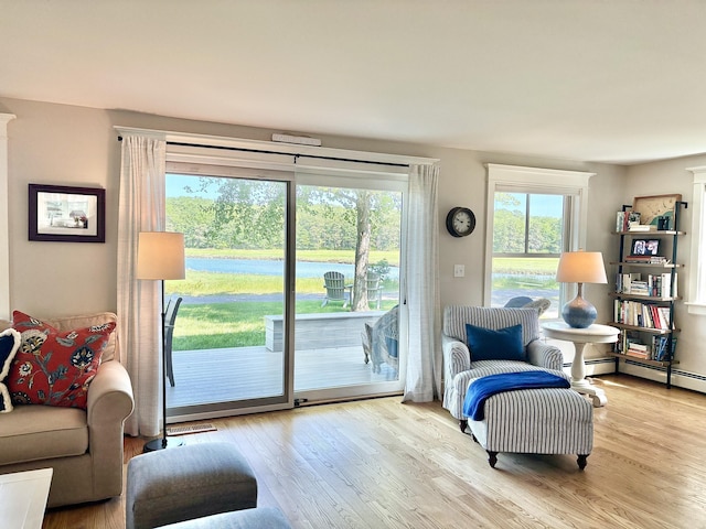 13 Norwood Ln, Kennebunkport, ME 04046 - living area featuring wood finished floors, a water view, and a baseboard radiator