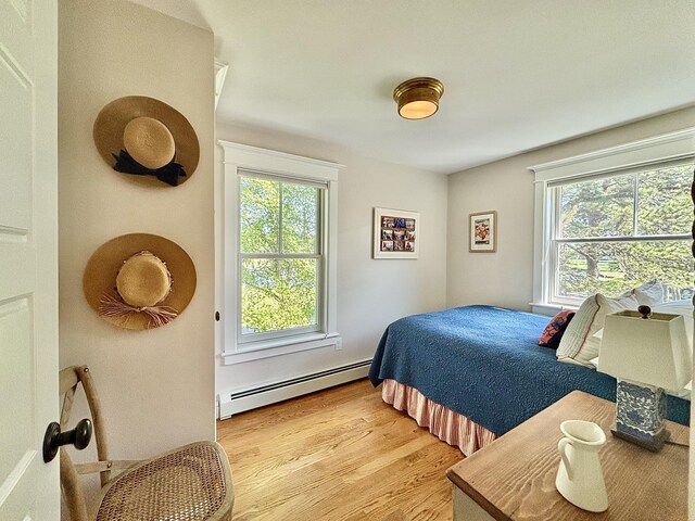 13 Norwood Ln, Kennebunkport, ME 04046 - bedroom with baseboard heating, multiple windows, and light wood-style floors
