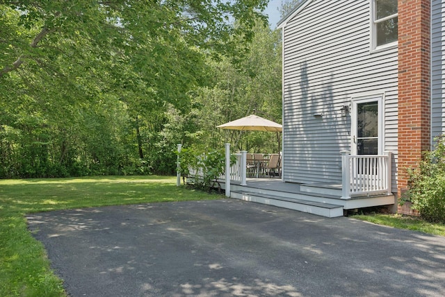 46 Label Ave, Portland, ME 04103 - view of side of property featuring a deck, a lawn, and a patio area