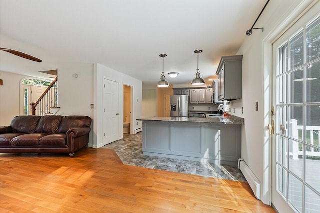 4 Acorn Ln, Lewiston, ME 04240 - kitchen with gray cabinets, stainless steel fridge with ice dispenser, a baseboard radiator, light wood finished floors, and open floor plan