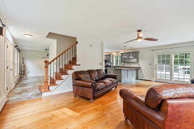 4 Acorn Ln, Lewiston, ME 04240 - living room featuring a baseboard radiator, light wood-style flooring, a ceiling fan, stairs, and a baseboard heating unit