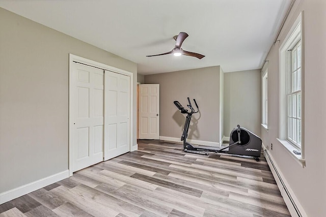 4 Acorn Ln, Lewiston, ME 04240 - exercise room featuring light wood-style floors, a ceiling fan, and baseboard heating