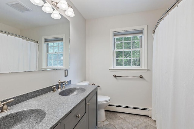 4 Acorn Ln, Lewiston, ME 04240 - full bath with a baseboard heating unit, healthy amount of natural light, double vanity, and tile patterned flooring